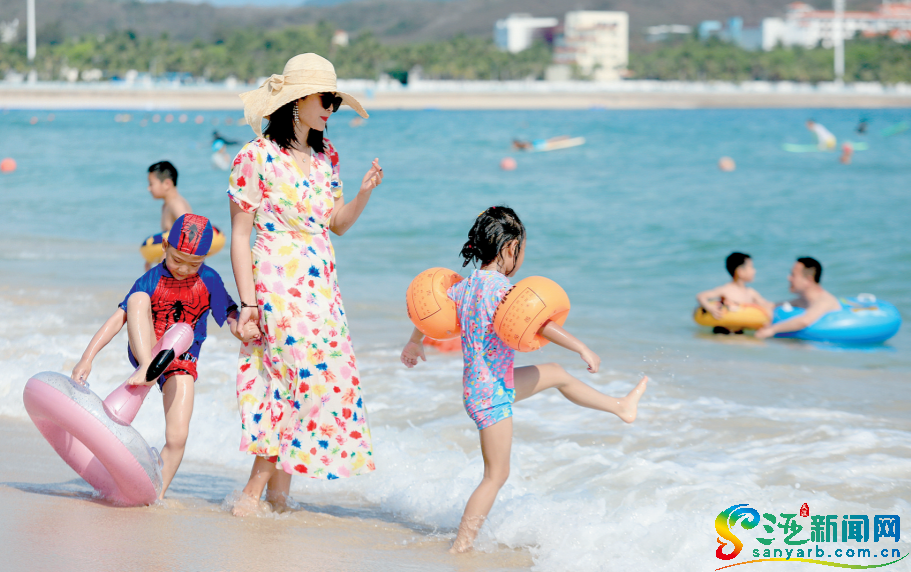 游客在大东海景区踏浪嬉戏，享受阳光休闲度假。三亚传媒融媒体记者 袁永东 摄